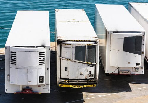Barcelona, Spain - May 2, 2015: Row of refrigerated white containers waiting to board at the port of Barcelona.